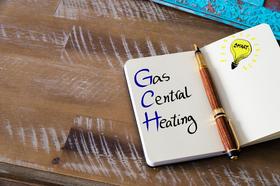 Image of note book with the words gas central heating written inside. 