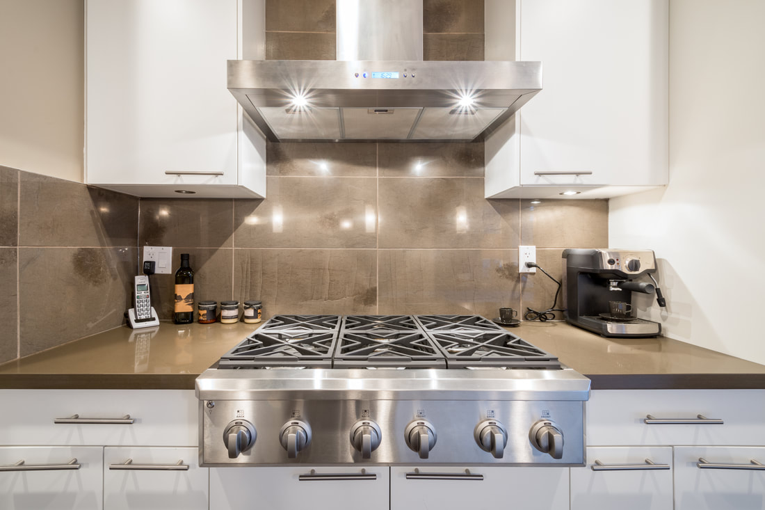 Image of modern kitchen with 6 ring gas hob in the centre. 